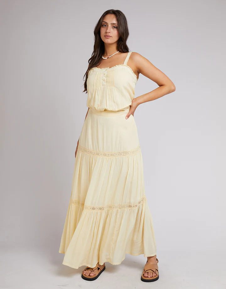Yellow All About Eve skirt has a fixed waistband with elastic at the back, lace trims, and a tiered hem