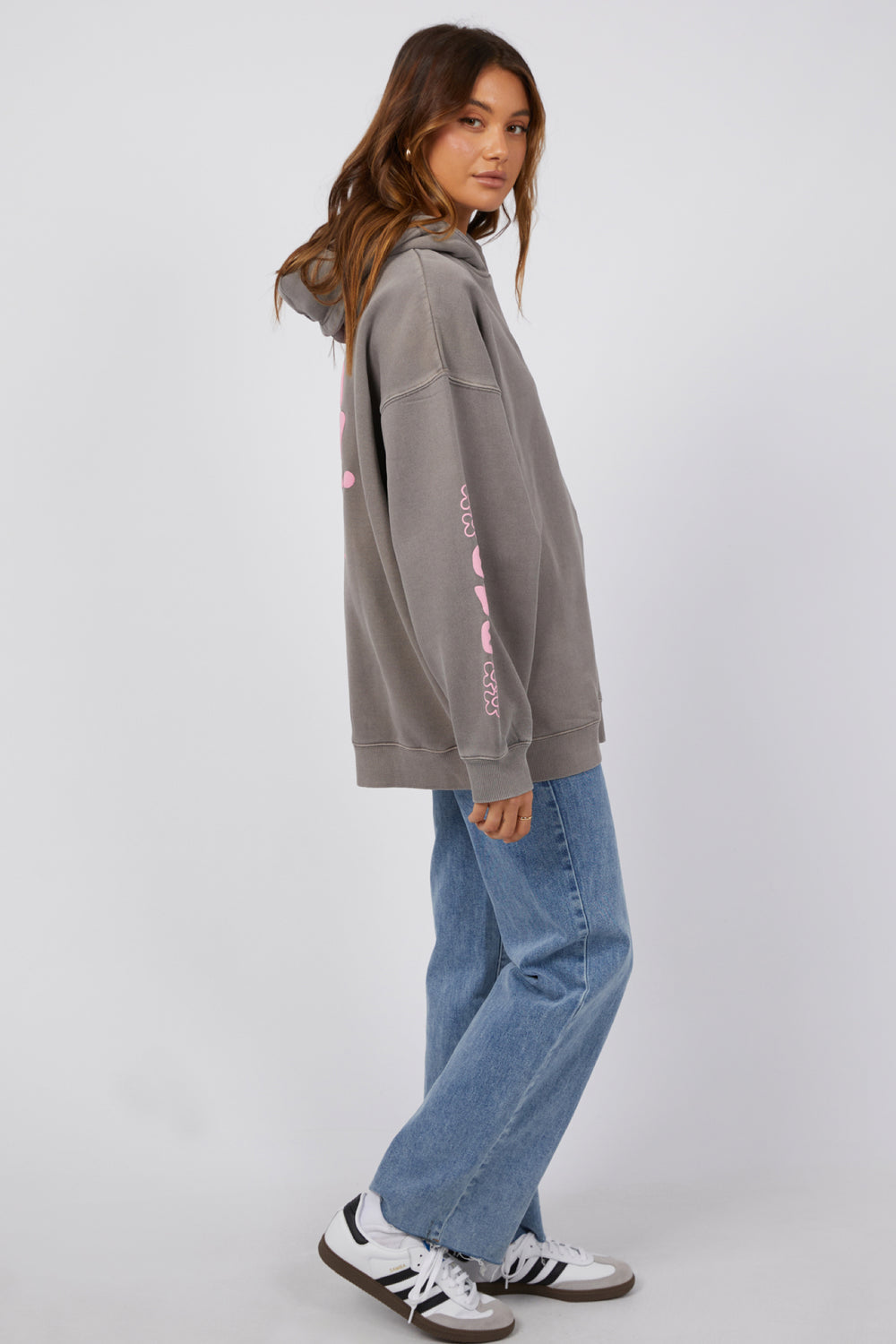 Grey women's hoodie available in New Zealand. Oversized fit, with pink writing