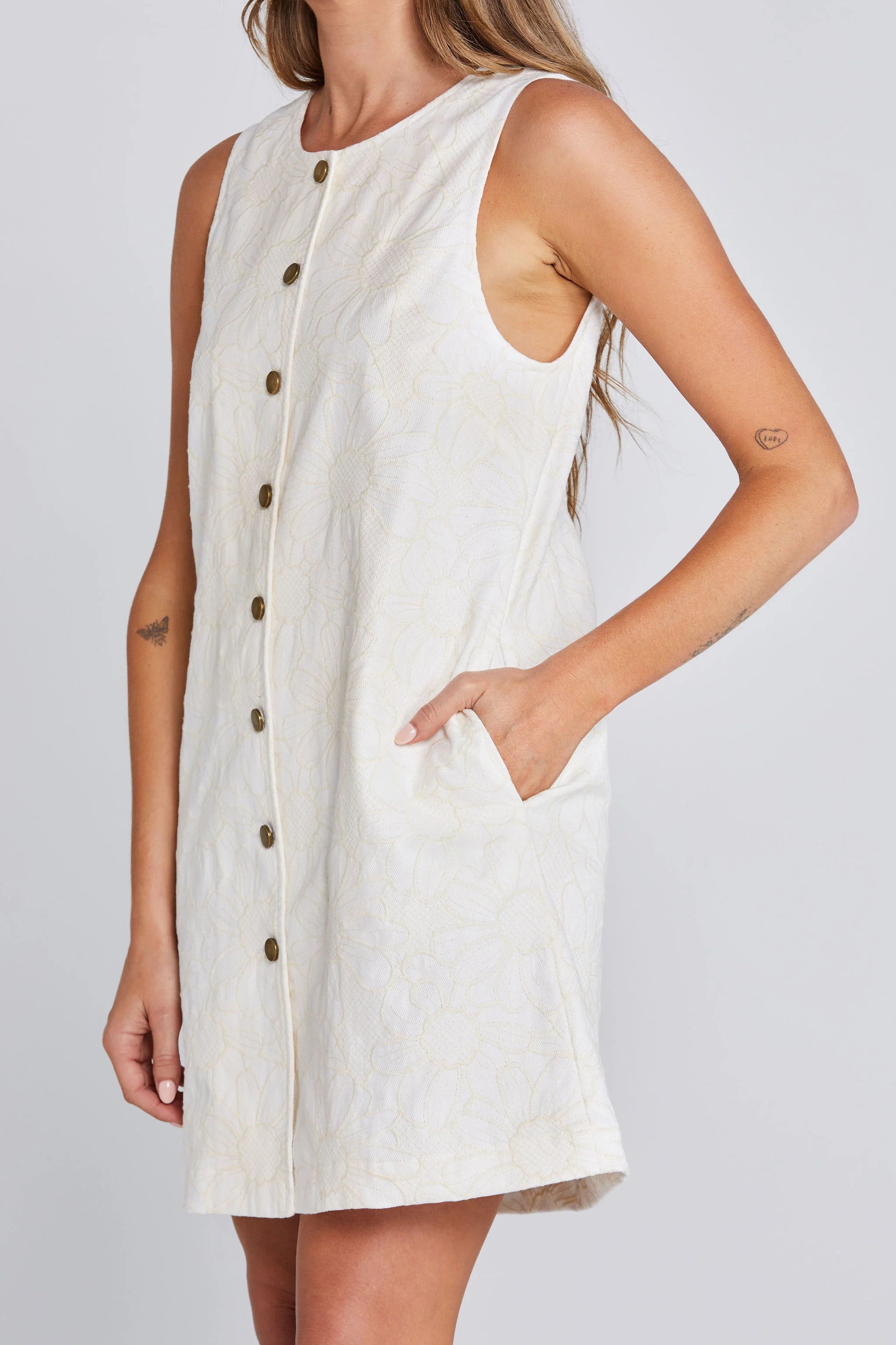 sleeveless, short cream dress