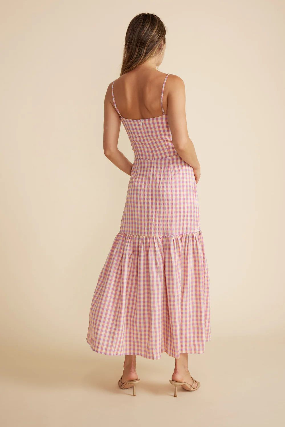 From Minkpink the Madison Sundress features a tie at the bust with a keyhole cut out, a mock button front and a gathered skirt