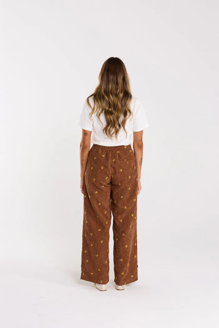 Front pleats,elasticated back. Pockets up front, welt pocket behind, all in a floral embroidered cord. cotton