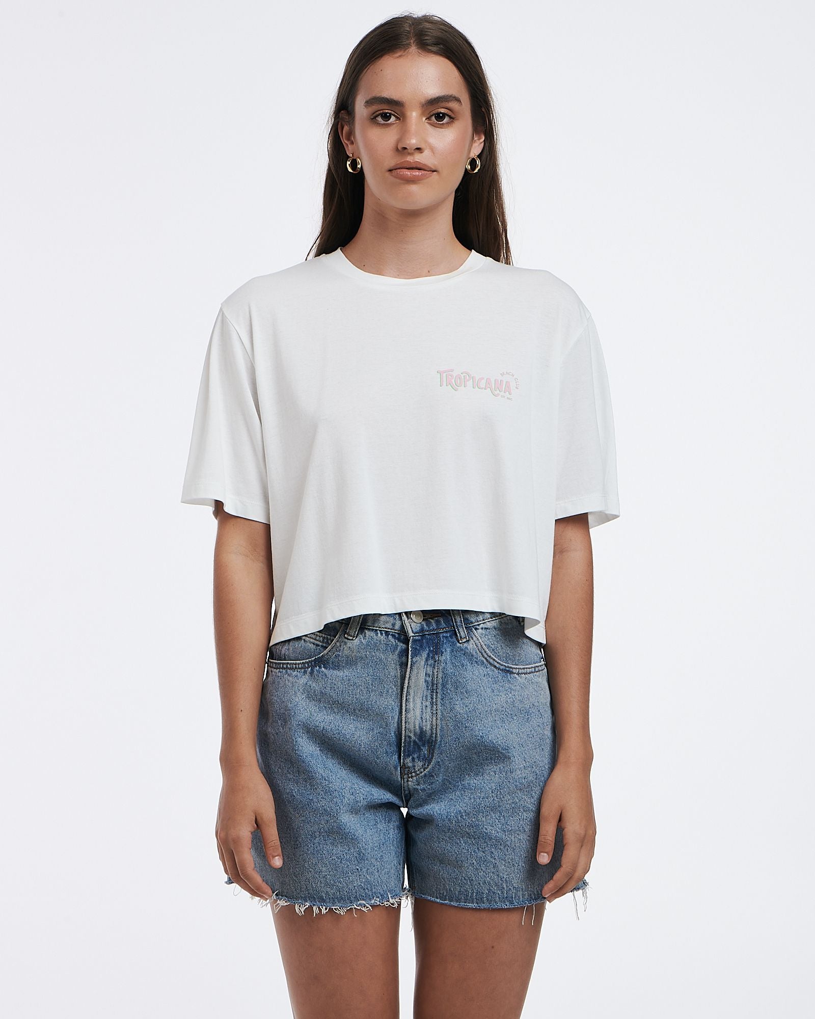 This cropped white tee features a subtle graphic and boxy shape.