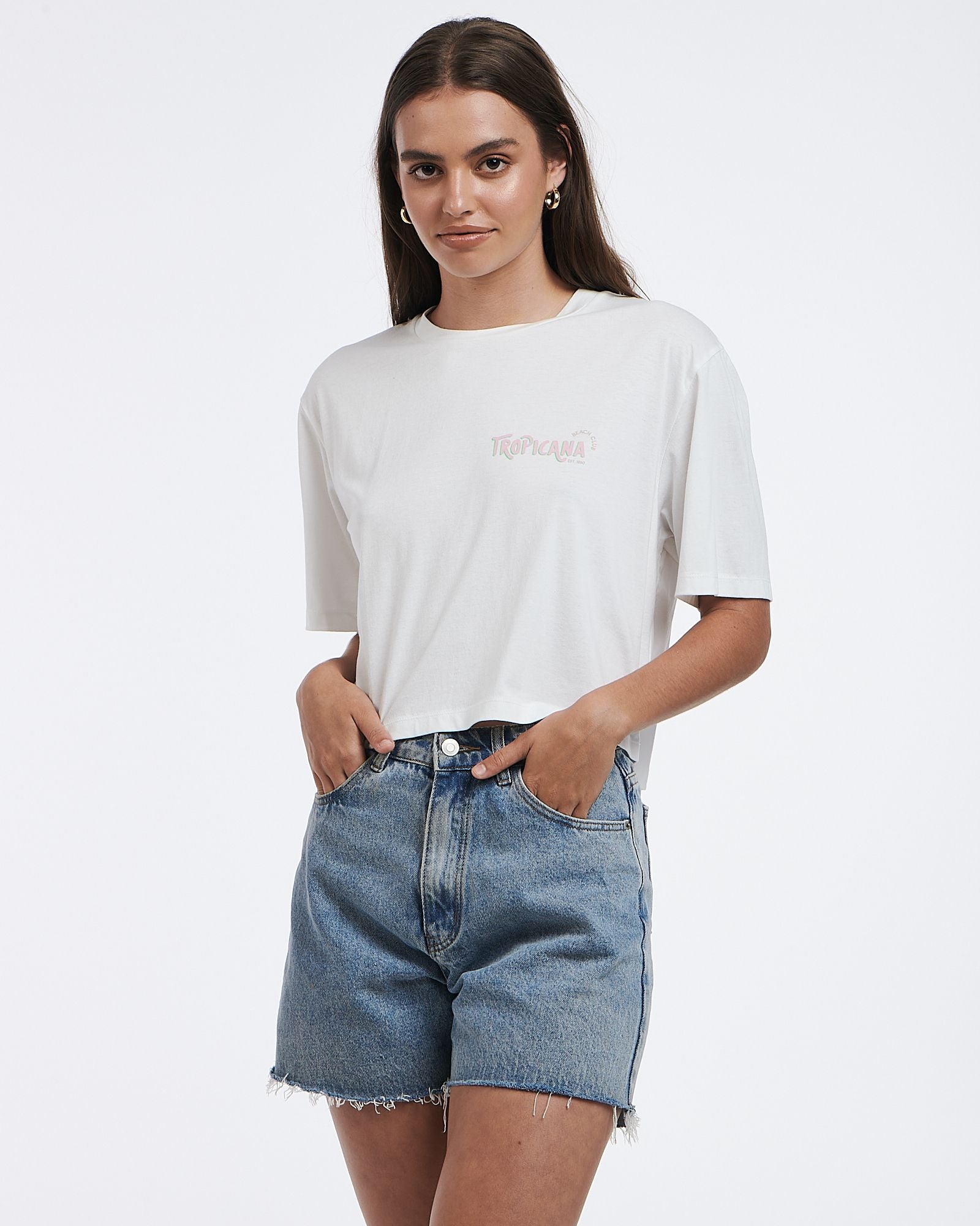 This cropped white tee features a subtle graphic and boxy shape.