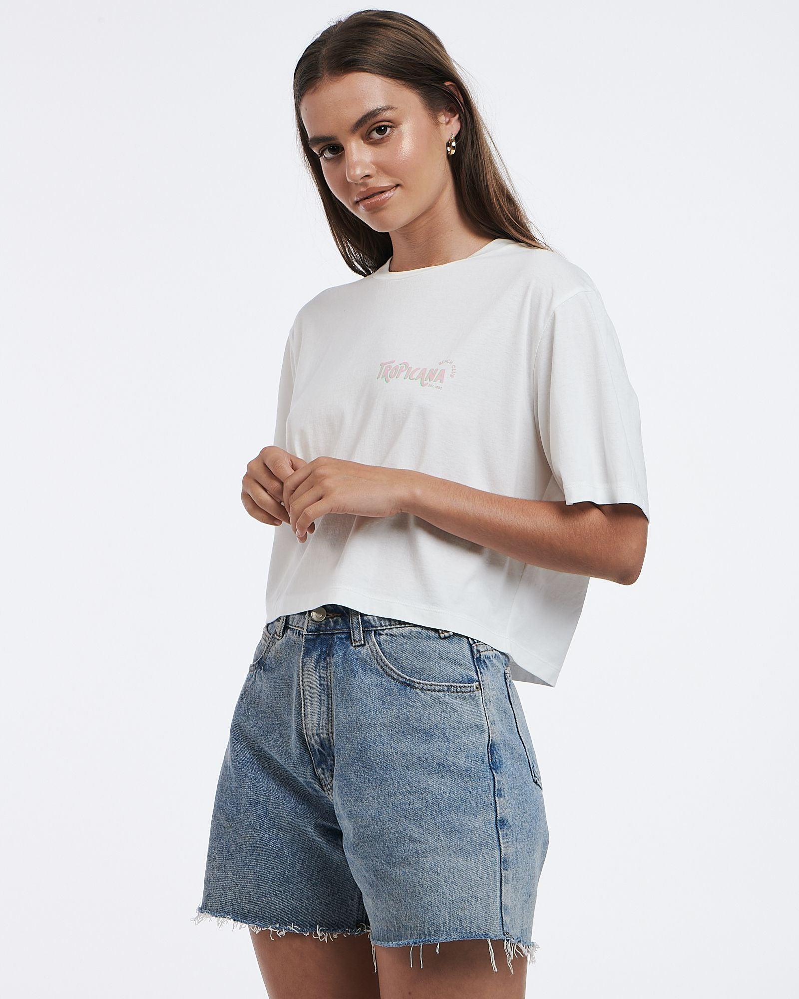 This cropped white tee features a subtle graphic and boxy shape.