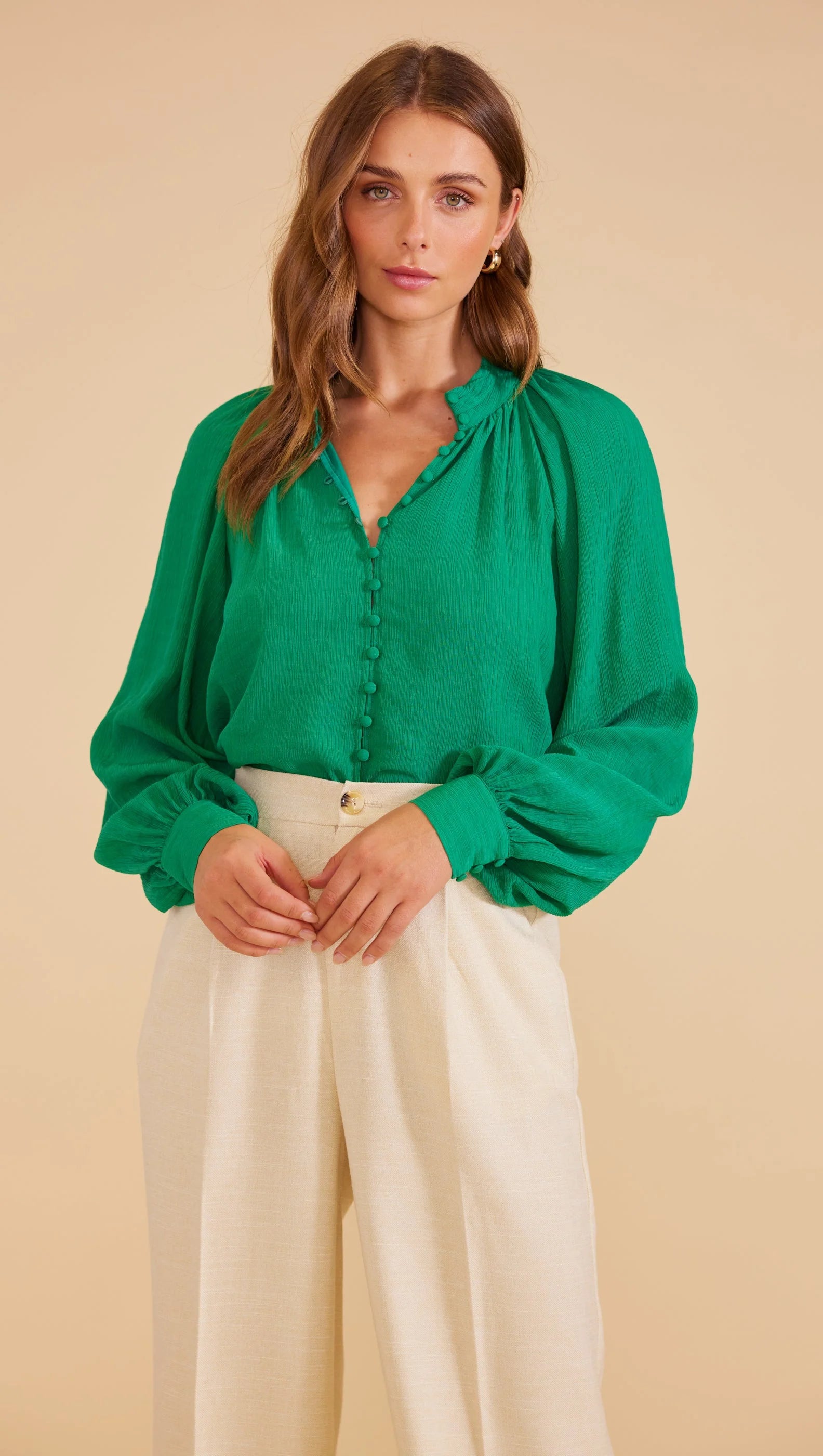 Full-length blouson sleeves with buttoned cuffs, Collarless design, buttons down the centre front and relaxed fit.