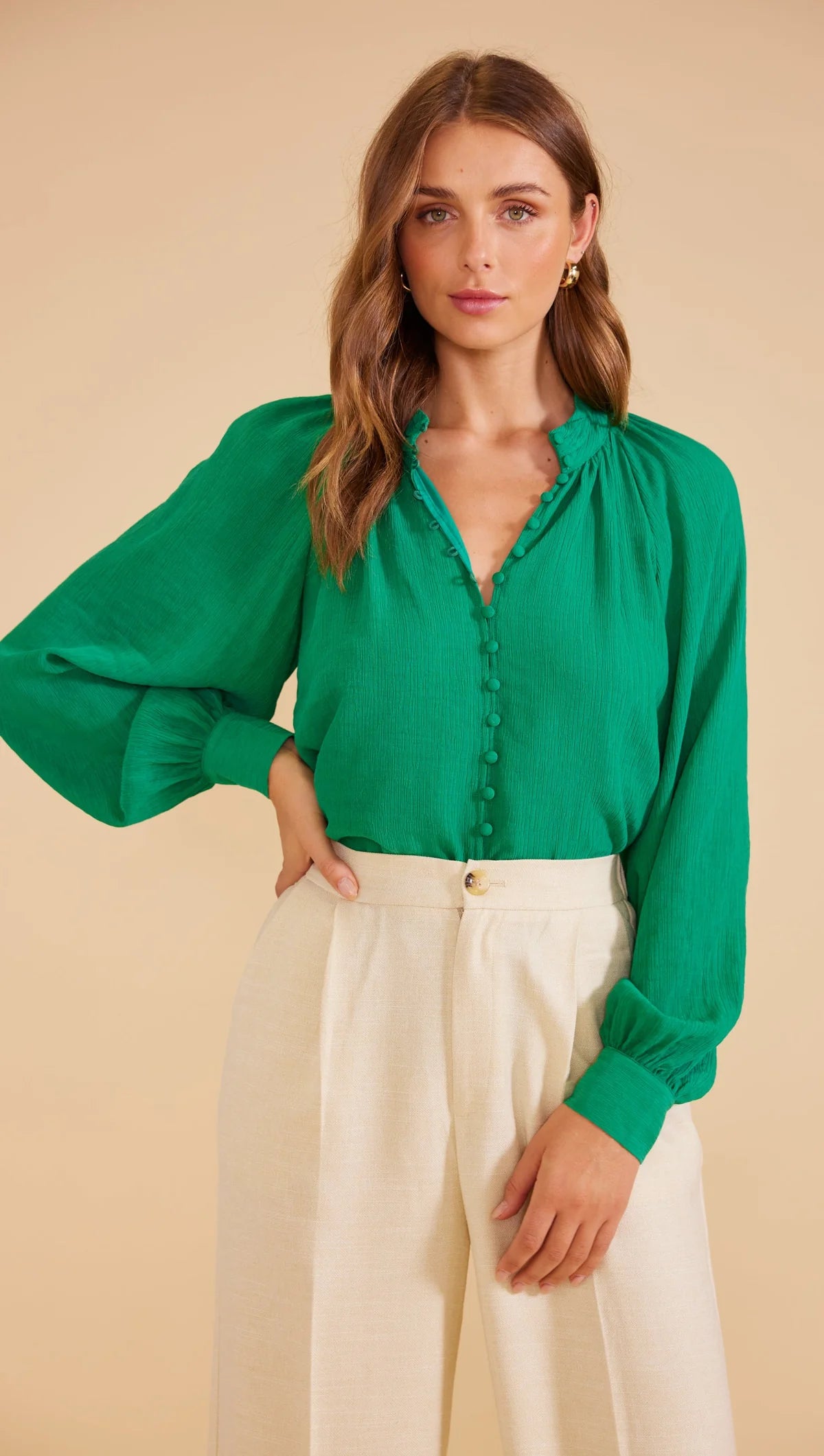 Full-length blouson sleeves with buttoned cuffs, Collarless design, buttons down the centre front and relaxed fit.
