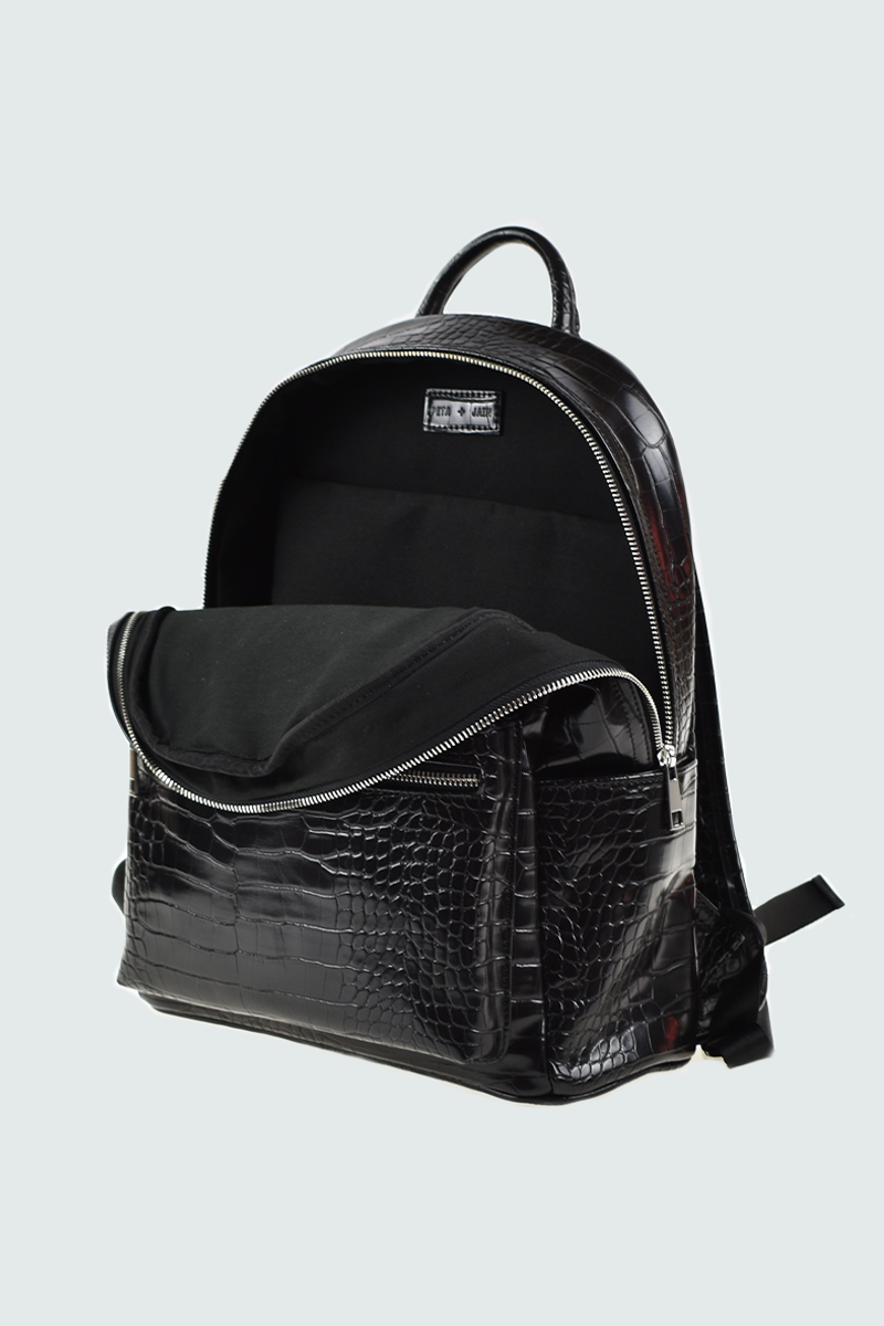 Black back pack with a top handle, laptop compartment and vegan embossed leather