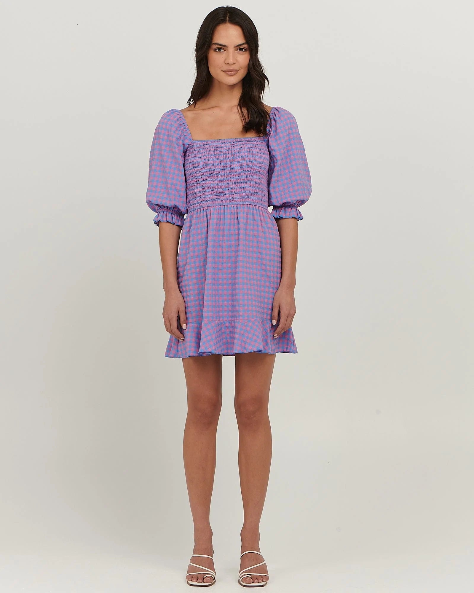 Puff sleeve cotton mini dress with
shirred bodice; straight neckline; flared skirt with frill at hem