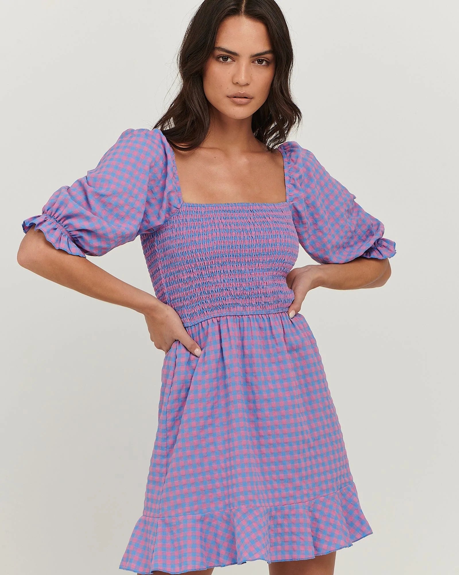 Puff sleeve cotton mini dress with
shirred bodice; straight neckline; flared skirt with frill at hem