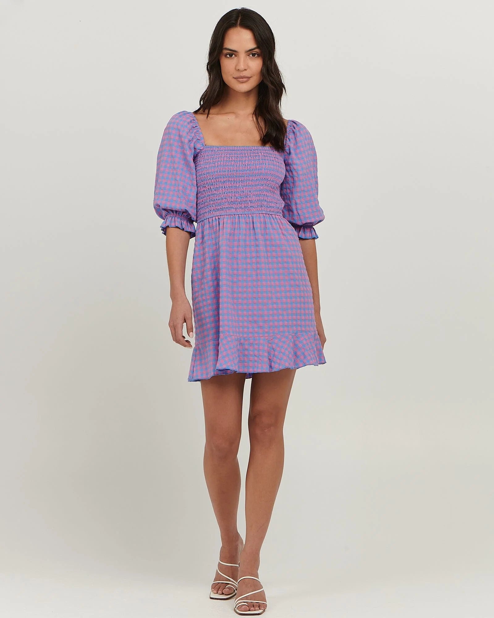 Puff sleeve cotton mini dress with
shirred bodice; straight neckline; flared skirt with frill at hem