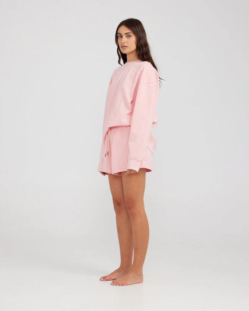 Sweatshirt in a light pink colour available in NZ. From Charlie Holiday this sweatshirt is great for spring and summer