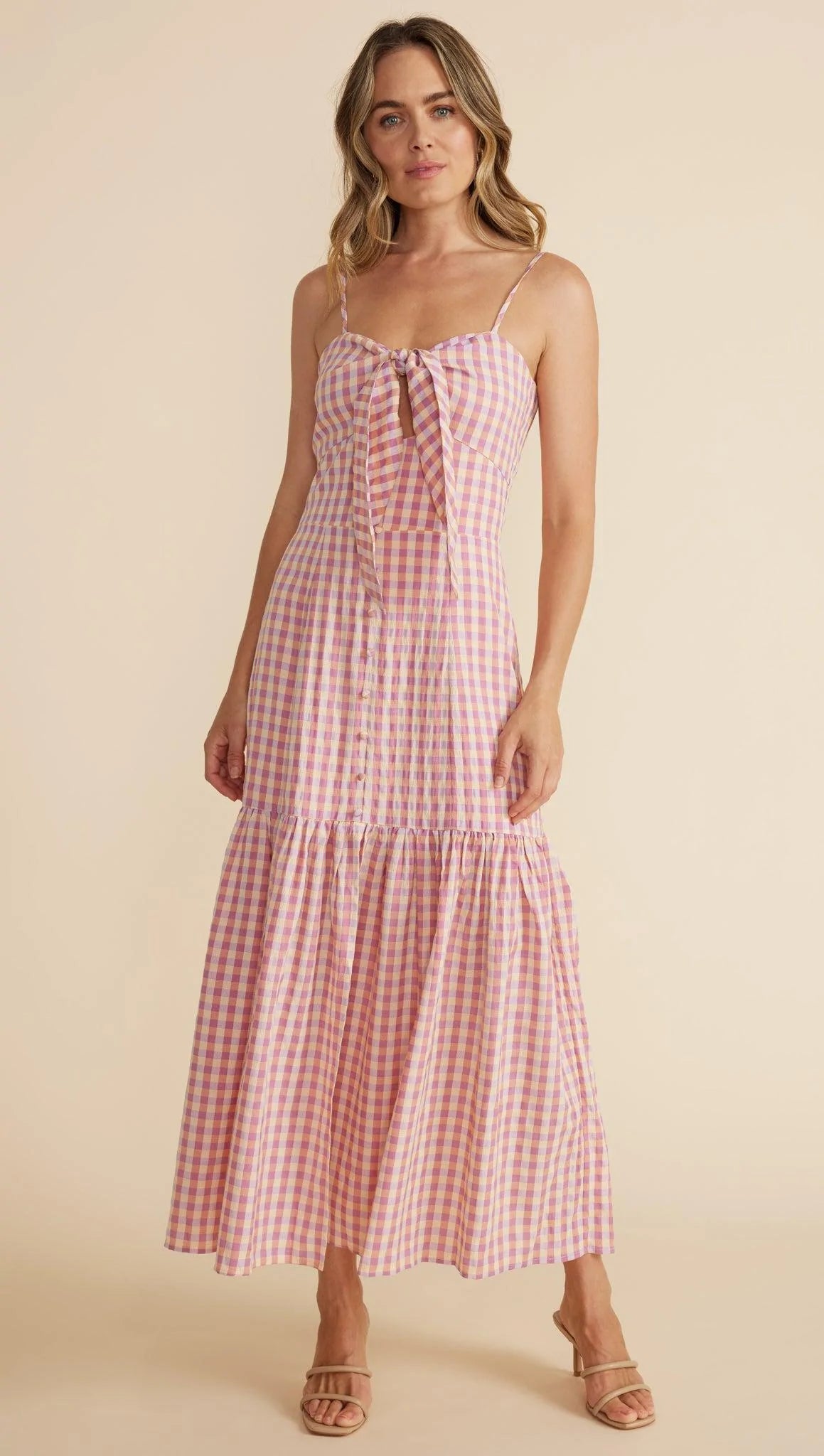 From Minkpink the Madison Sundress features a tie at the bust with a keyhole cut out, a mock button front and a gathered skirt