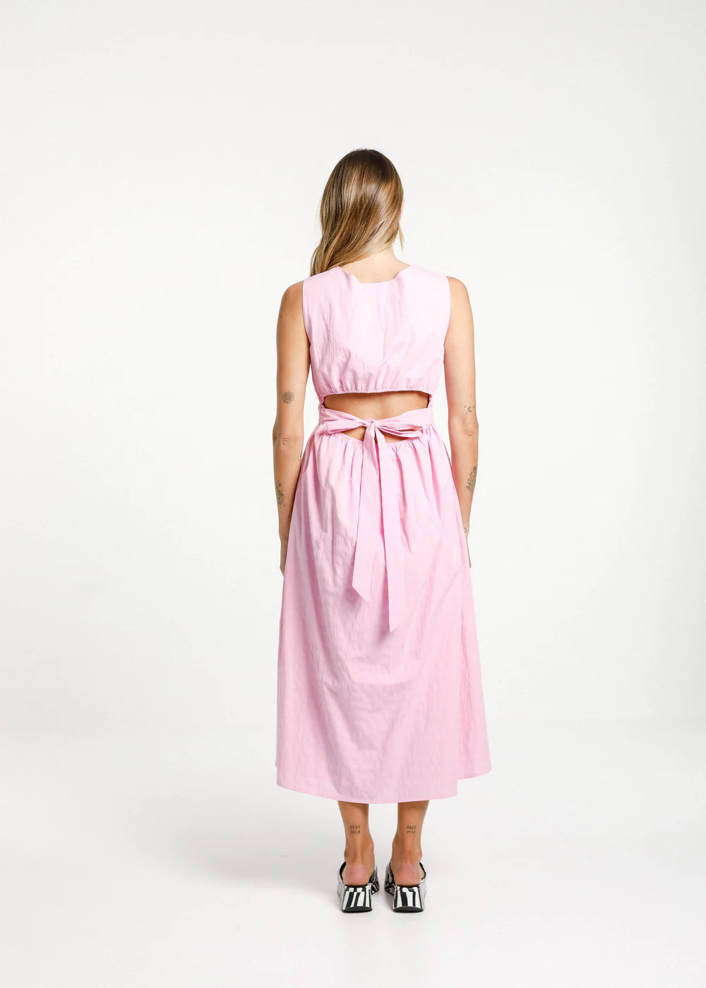 pink dress with tie in back and rounded neckline