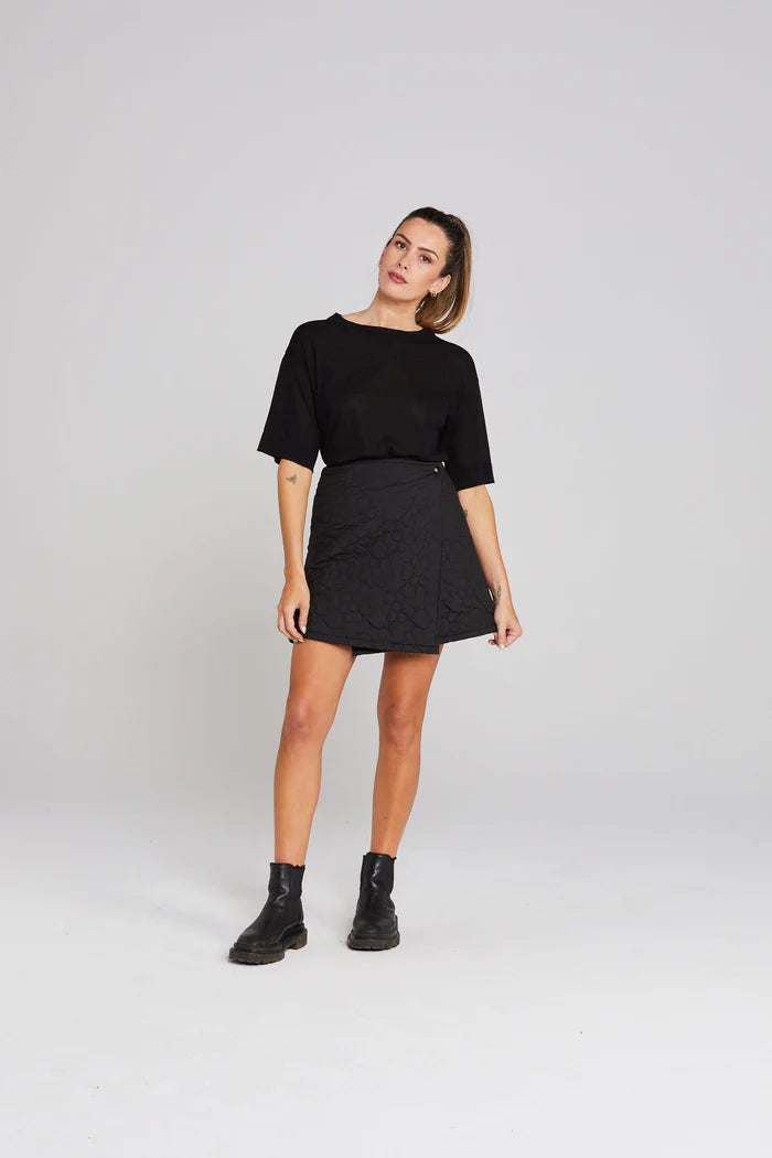 Quilted Mini, Staggered Hemline at Front, Snap Button Closures
Back Darts