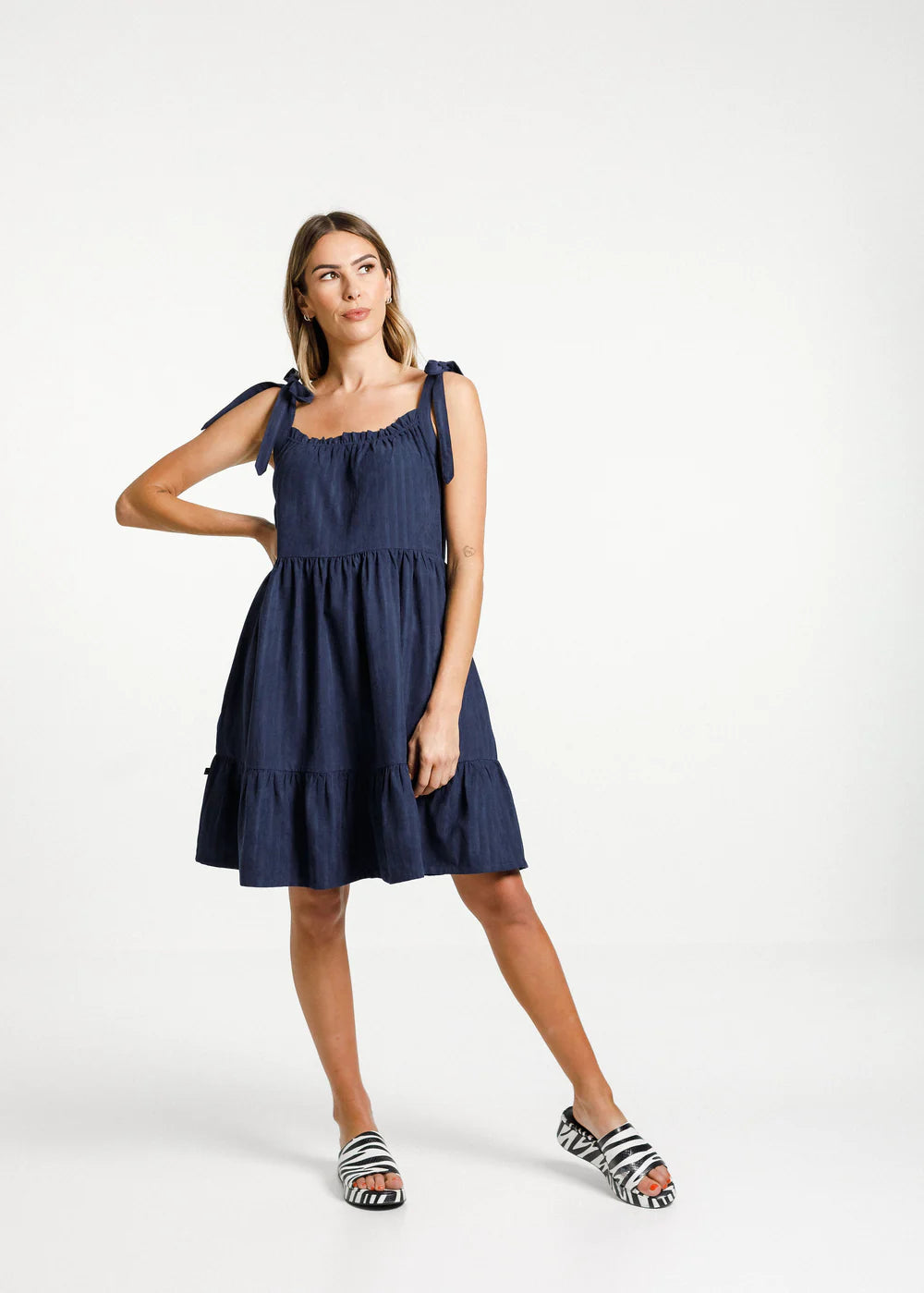 Women's navy blue dress from Thing Thing. Zig dress with square cut front, gathered layers and deep pockets 