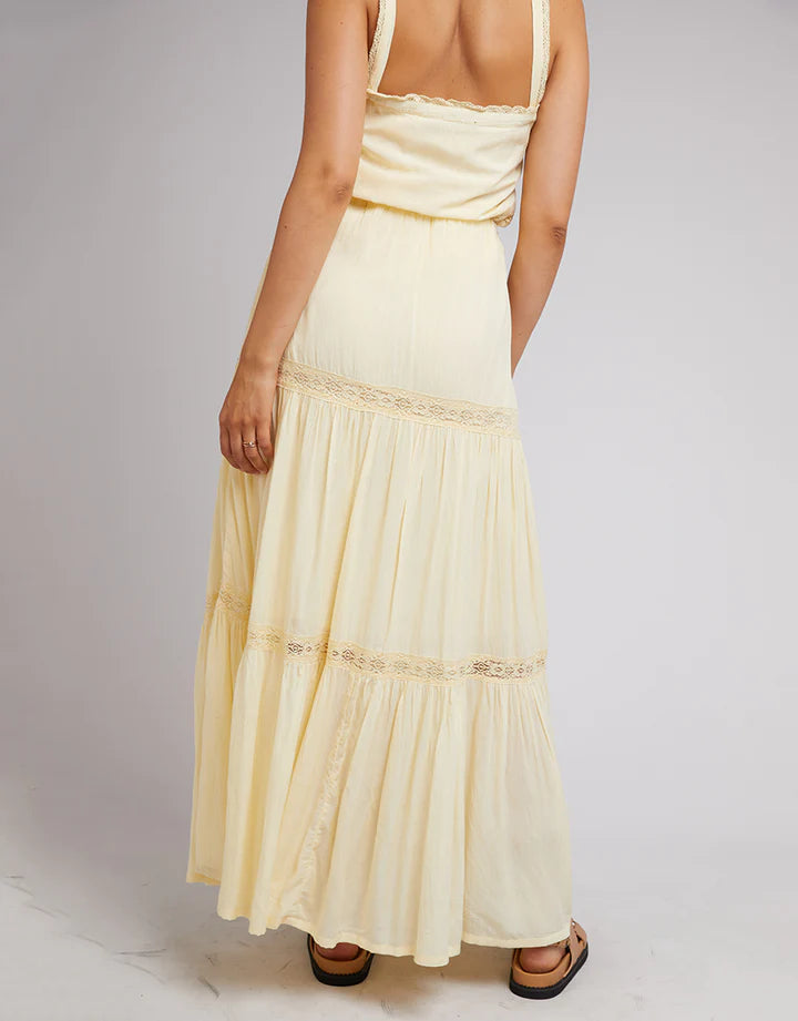 Yellow maxi skirt has a fixed waistband with elastic at the back, lace trims, and a tiered hem