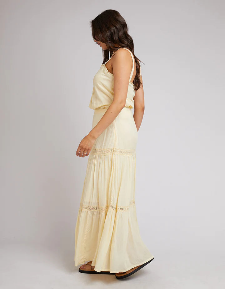 Yellow All About Eve skirt has a fixed waistband with elastic at the back, lace trims, and a tiered hem