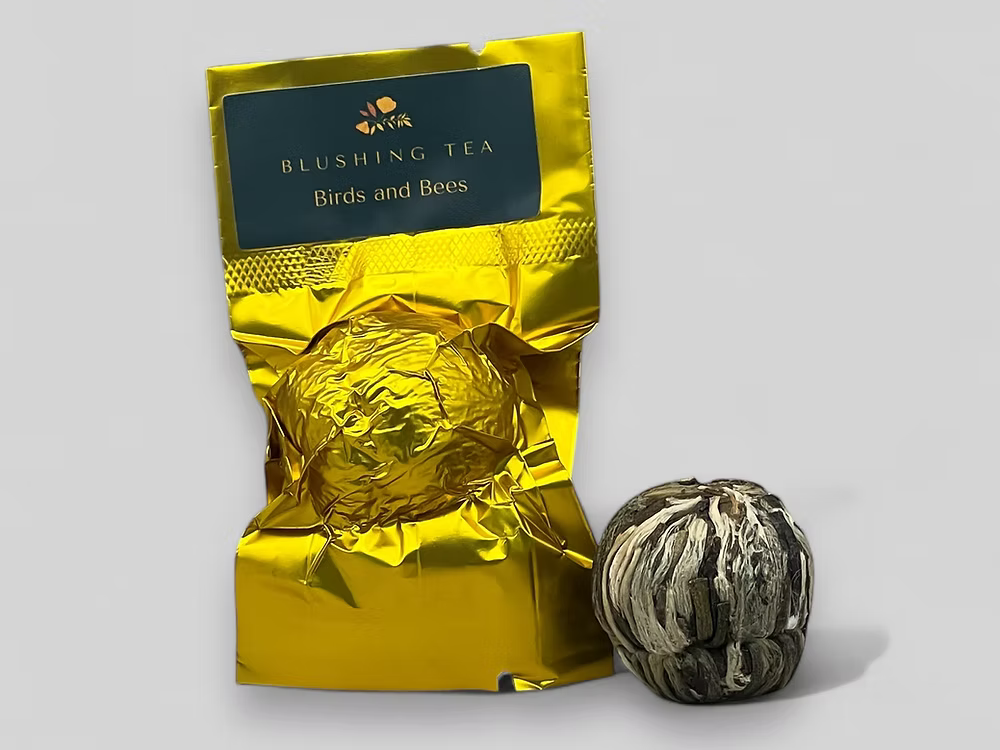 gold foil package of Blushing Tea with a tea ball 