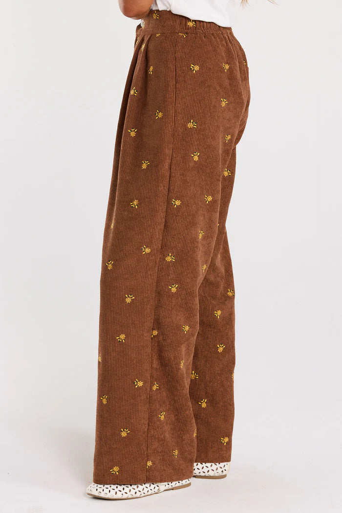 Front pleats,elasticated back. Pockets up front, welt pocket behind, all in a floral embroidered cord. cotton