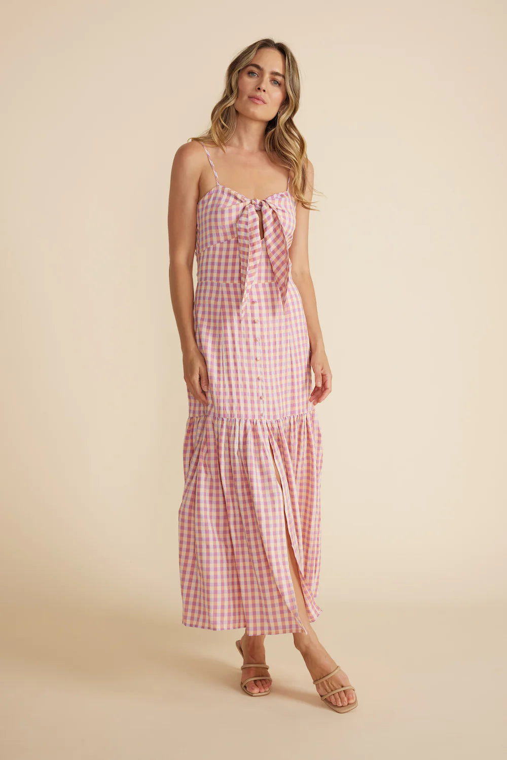 From Minkpink the Madison Sundress features a tie at the bust with a keyhole cut out, a mock button front and a gathered skirt